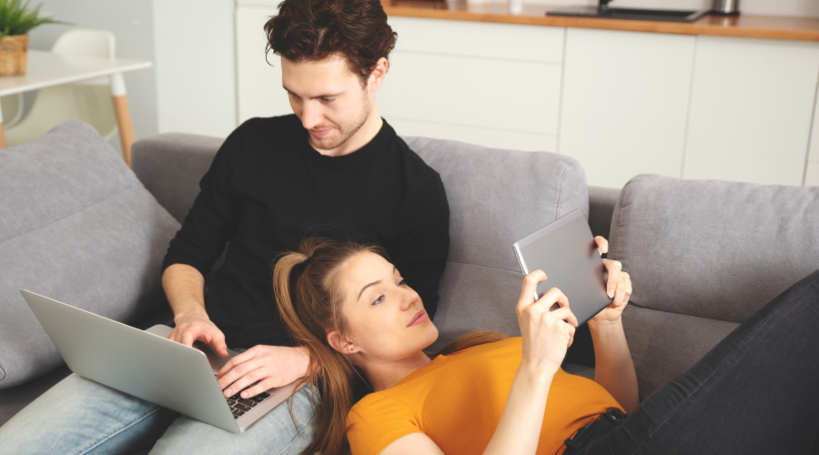 couple using the internet at home, showing the difference between broadband and wifi